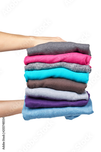 pile of multi color fabric texture with hand, wool cloth isolated on white background