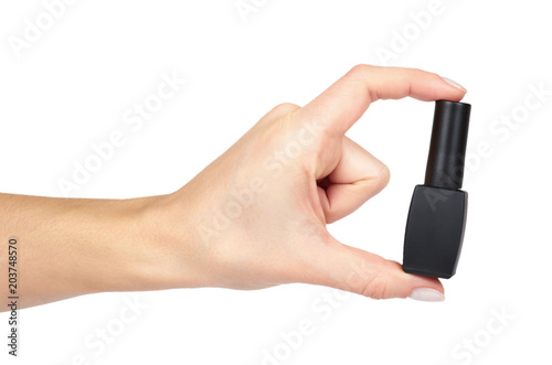 Black nail polish bottle with hand isolated on white background