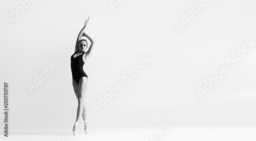 Graceful ballerina dancing in art performance.