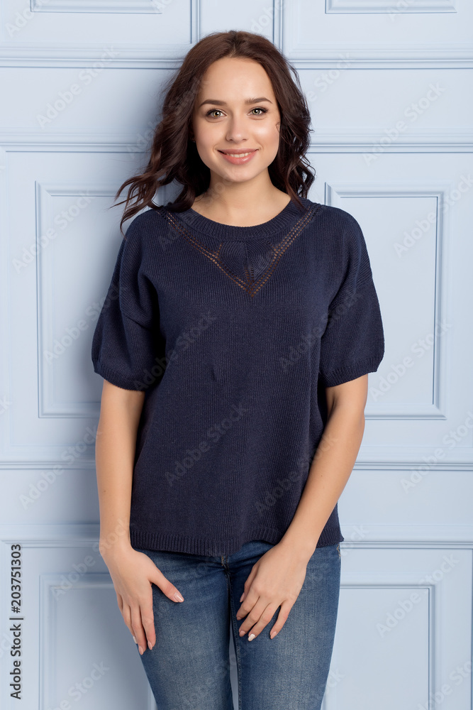 beautiful cute girl with a smile demonstrates knitted clothes beautiful cute girl with a smile demonstrates knitted clothes