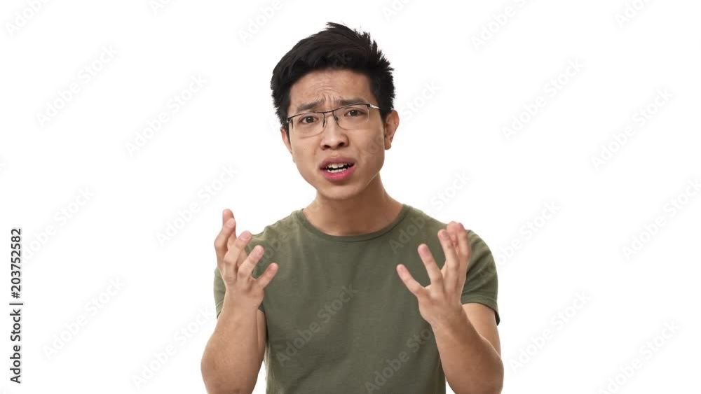 Portrait of perplexed asian man 20s wearing glasses being upset and screaming why in incomprehension, isolated over white background. Concept of emotions Portrait of perplexed asian man 20s wearing glasses being upset and screaming why in incomprehension, isolated over white background. Concept of emotions