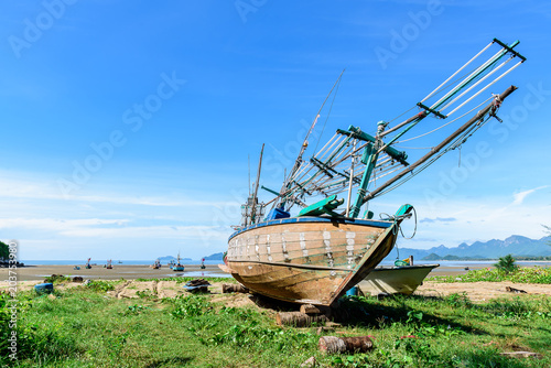 Fisherman boat on the beach with sunlight.