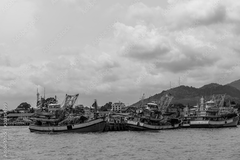 Fototapeta premium Fisherman boat on the sea with black and white.