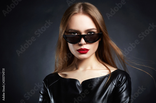 Woman in Sunglasses and Leather dress