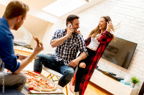 Young friends eating pizza ...