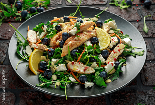 Fresh Chicken salad with Blueberries, feta, carrots, nuts and green vegetables. healthy food concept