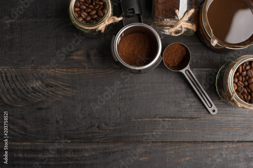 Preparation of coffee, ground coffee, coffee beans, on a dark background, top view with empty space for writing or advertising