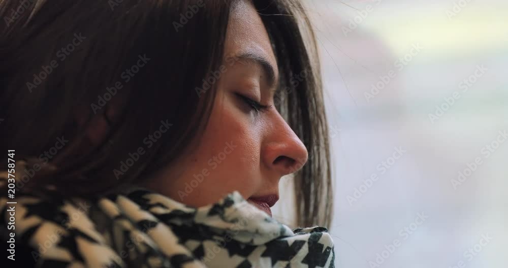 Candid authentic profile of woman face on commute travelling by train with background landscape in motion in 4K2