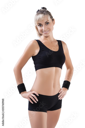 beautiful sports female posing with hands on hips looking at cam