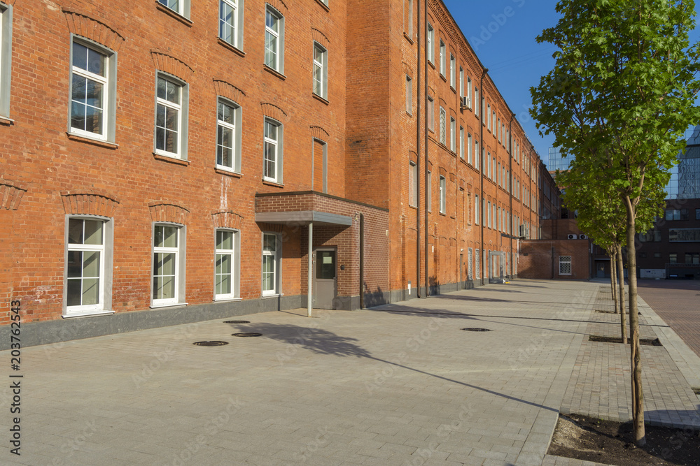 Office building of red brick in the yard of the old factory