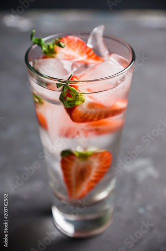 Cocktail with ripe strawberry on the rustic background. Selective focus.