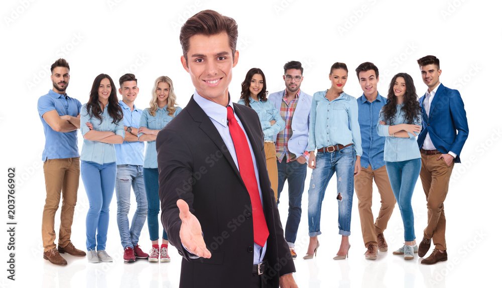 Obraz premium young businessman welcomes you to his team with a handshake