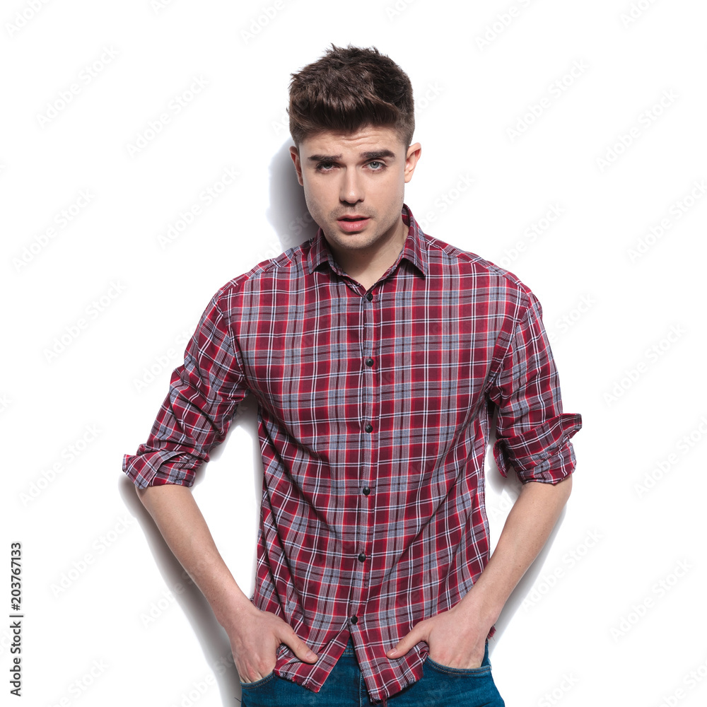 portrait of seductive young man with hands in pockets portrait of seductive young man with hands in pockets