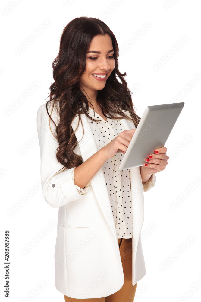 young and attractive businesswoman tapping on a tablet young and attractive businesswoman tapping on a tablet