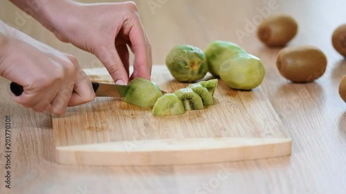 Cutting a kiwi fruit, close-up. photo