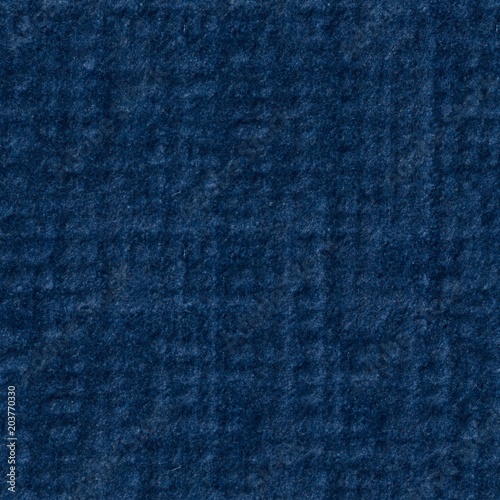Saturated blue paper texture with relief surface. Seamless square background, tile ready.