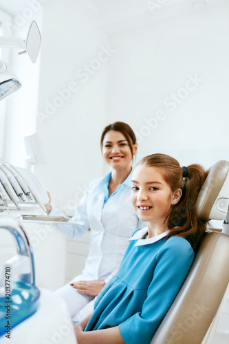 Dental Health. Dentist And Happy Girl In Dentistry Office