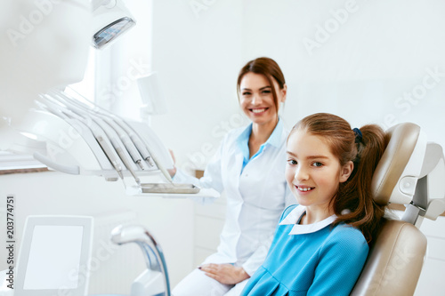 Dental Health. Dentist And Happy Girl In Dentistry Office