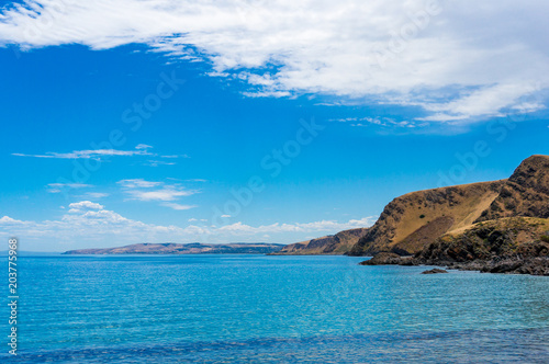 Mountain coastline with deep blue ocean water landscape