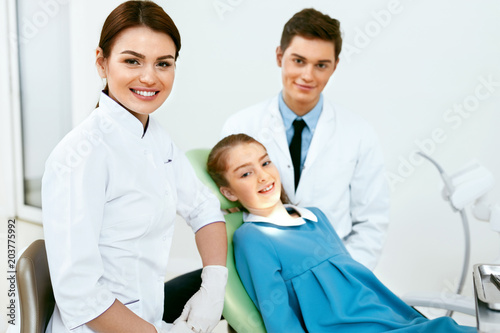 Stomatology. Dentistry Doctors And Patient In Dentist Office