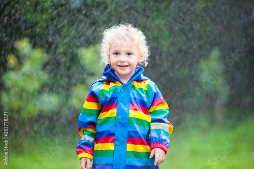 Little boy playing in the rain © famveldman