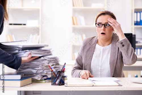 Businesswoman very busy with ongoing paperwork