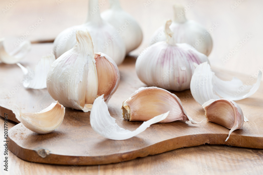 Garlics on wooden board Garlics on wooden board
