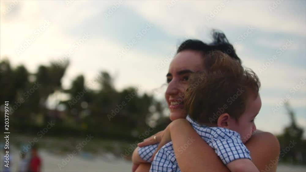 Young family, mother hugging her son on the coast. Happy family, along the seacoast. Young family, mother hugging her son on the coast. Happy family, along the seacoast.