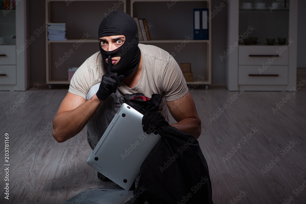 Burglar wearing balaclava mask at crime scene Burglar wearing balaclava mask at crime scene