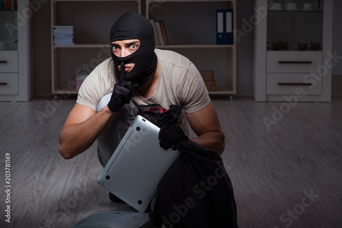 Burglar wearing balaclava mask at crime scene