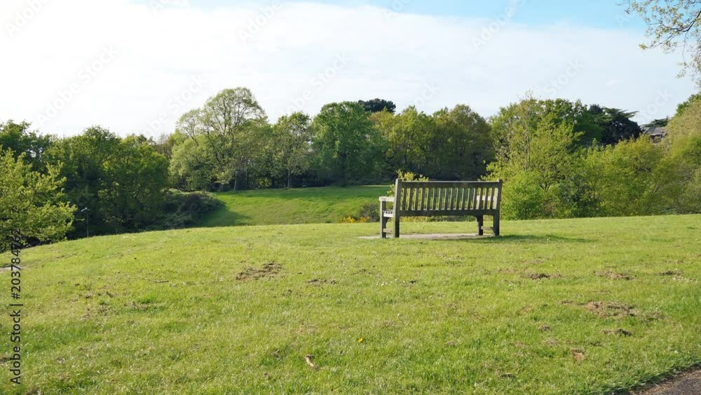 A wooden bench on top of a hill.