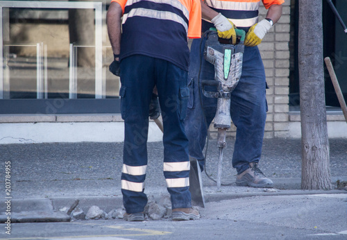 Workers repair the road.