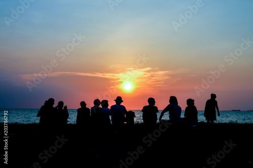 silhouette family meeting look sunset on beach
