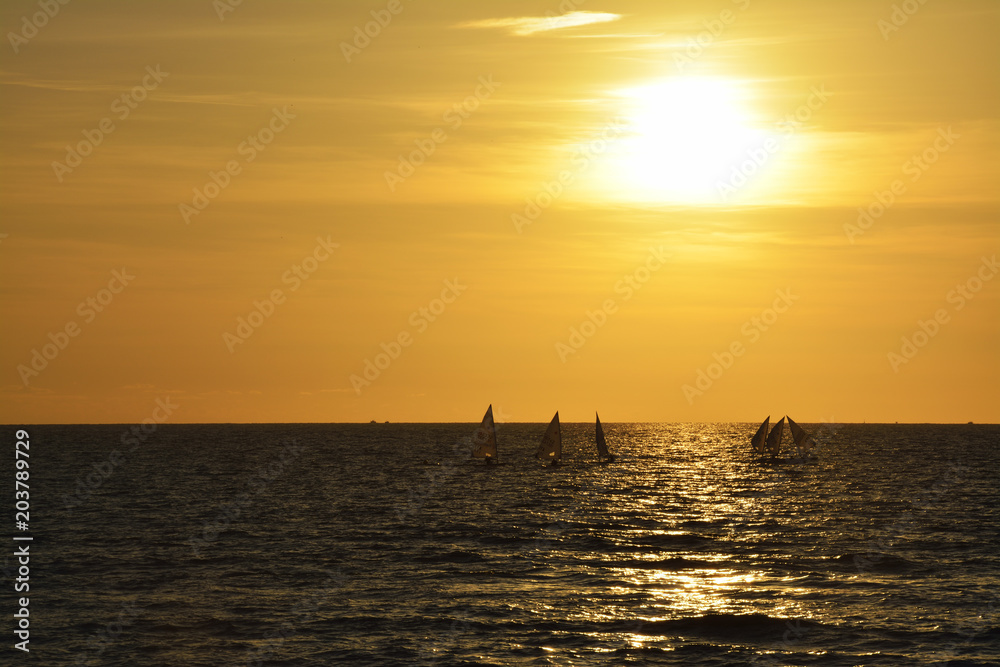 Boats Sailing On Sea Against Sky During Sunset