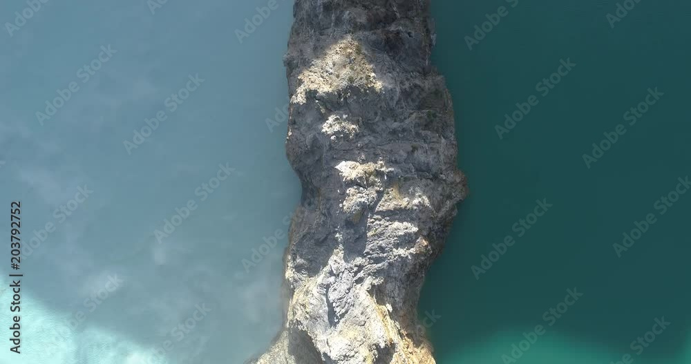 Kelimutu tri coloured volcano crater covered with mist an aerial view early morning, Indonesia