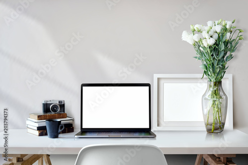 Fototapeta Naklejka Na Ścianę i Meble -  Stylish workspace with laptop computer and mockup poster on home or studio.
