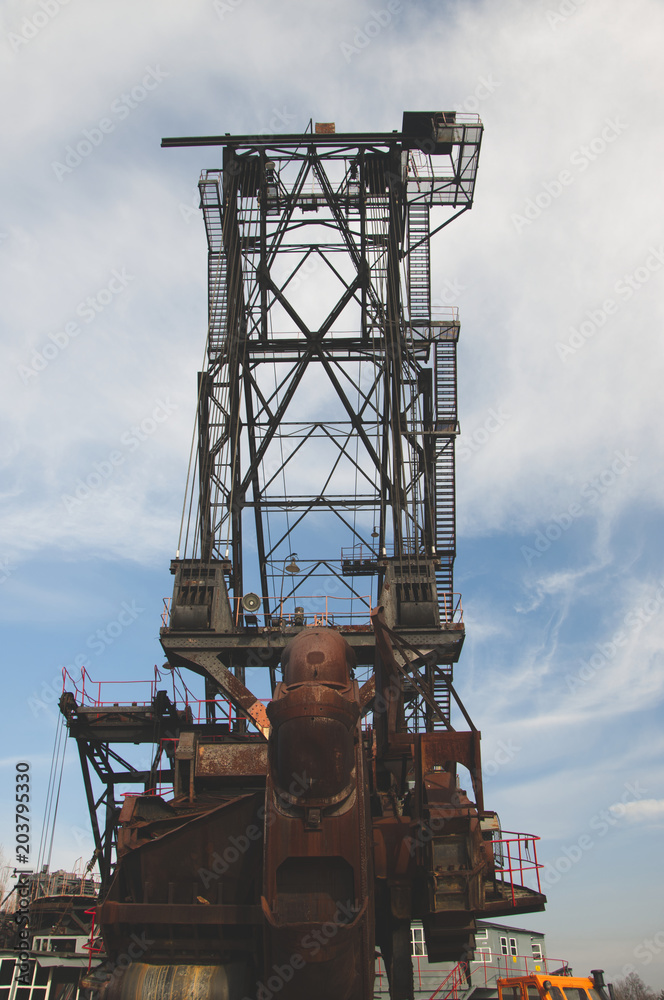 The huge coal mining machine captured with mining wheel from the front view. Vertical shot.
