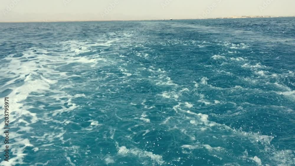 Ocean and Mediterranean Sea wake behind large Cruise ship. Hazy due to pollution smoke from smoke stacks and engine. Horizon in distance. Ocean and Mediterranean Sea wake behind large Cruise ship. Hazy due to pollution smoke from smoke stacks and engine. Horizon in distance.