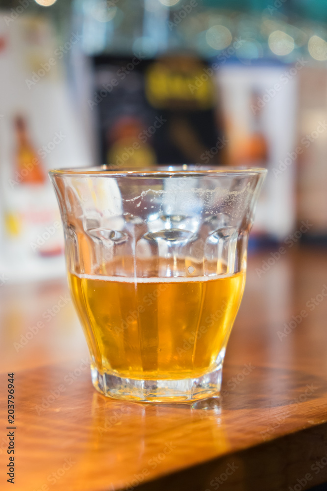 Alcoholic beverage on a wooden table in a pub. Alcoholic beverage on a wooden table in a pub.