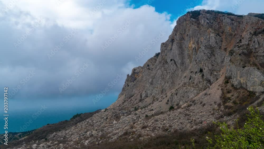 Clouds are running through a large rock. Crimea, Foros. 4K timelapse Clouds are running through a large rock. Crimea, Foros. 4K timelapse