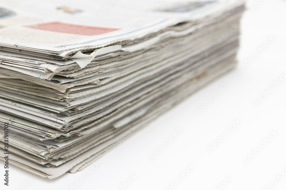 Closeup - Newspaper Stack on white table in work office Closeup - Newspaper Stack on white table in work office