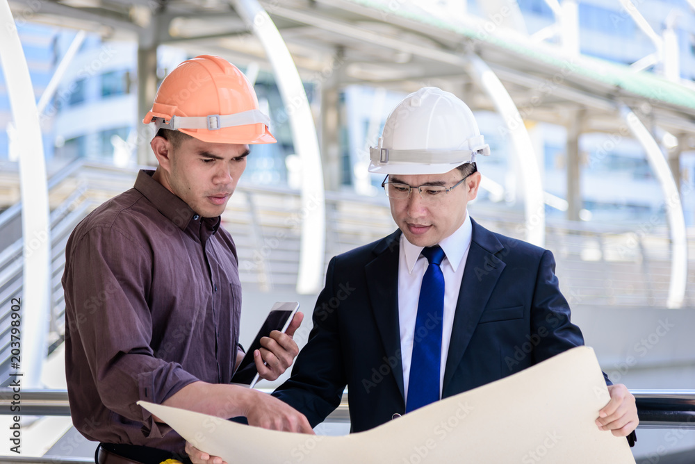 Two asian business and engineer man has planning and working for design buiding and city. Two asian business and engineer man has planning and working for design buiding and city.