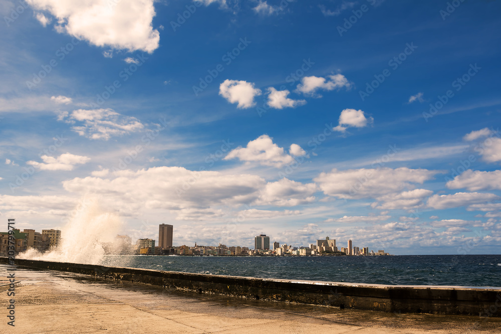 Promenade of the Malecon of Havana with crashing waves