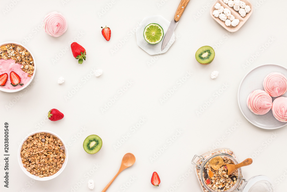 Healthy breakfast with yogurt, muesli, fruits, strawberry on grey background, flat lay, top view Healthy breakfast with yogurt, muesli, fruits, strawberry on grey background, flat lay, top view