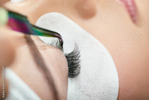 Fotografie Close up of making lashes with tweezers