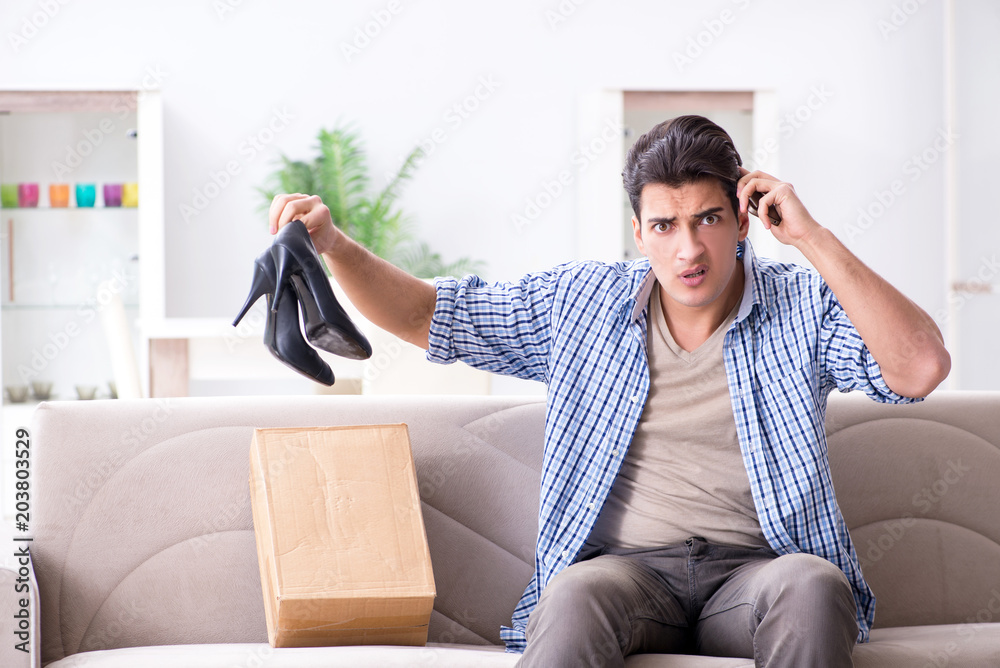 Man receiving wrong parcel with female woman shoes Man receiving wrong parcel with female woman shoes
