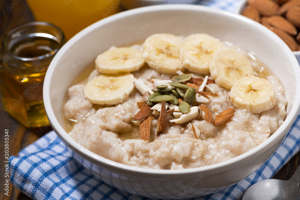 oatmeal with banana, honey and nuts, closeup