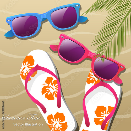Flip- flops in the sand, sun glasses and palm leaves