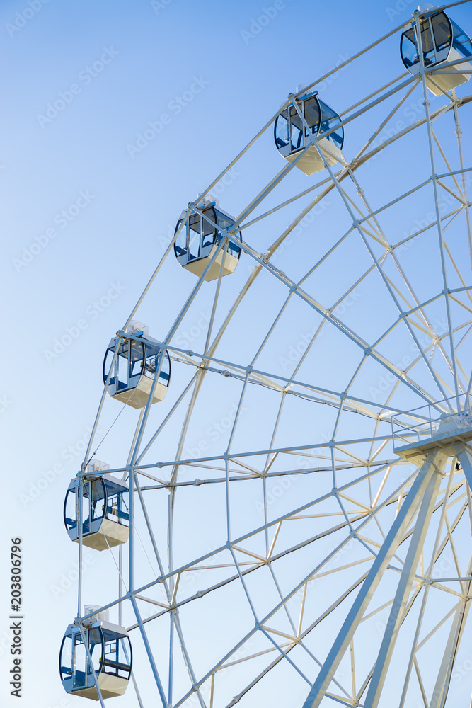 Ferris wheel on blue background vertically