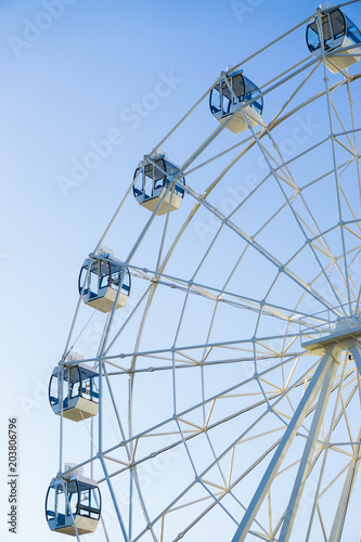 Ferris wheel on blue background vertically